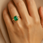 Emerald ring in bezel setting Hand